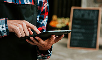 Photo of a businssowner using a tablet device
